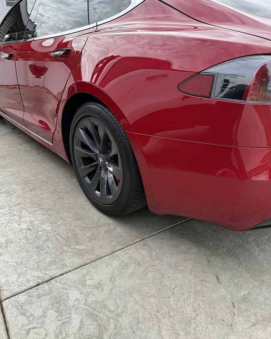 A red Tesla Model S with a deep gloss