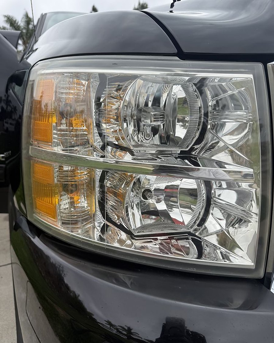 Clear headlights on a black Silverado after restoration